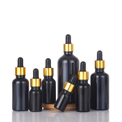 China Cosmetic custom supplier 10ml custom good price black matte dropper serum essential oil glass bottle rotating mouth gold lid for sale