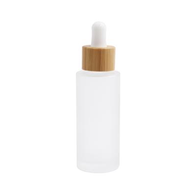 China Cosmetic Frosted Glass Dropper Bottle With Bamboo Lid 50ml 100ml Dropper Glass Bamboo Bottle for sale