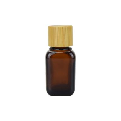 China Cosmetic Serum 15ml Square Glass Bottle With Screw Bamboo Lid Amber Bamboo Essential Oil Bottle for sale