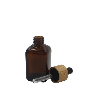 China Personal care glass bottle dropper overlap essential oil square bottle high quality bamboo bottle with bamboo dropper for sale