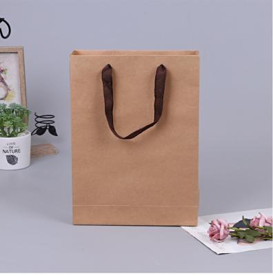 China Cheap Recycled Materials Kraft Paper Custom Gift Bags Plain Paper Packaging Personal Wedding Shopping Bags With Customized Logo for sale