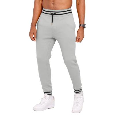 China Anti-pilling Customization Men&#39s Jogging Qatar Mens Polyester Stretch Tight Price Pants Solid Color Without Pattern for sale