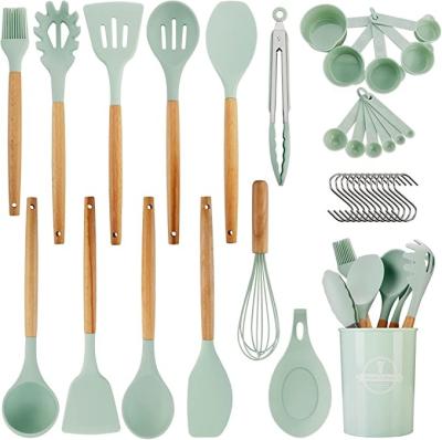 China BPA Sustainable Free Silicone Kitchen Utensil Cooking Set With Wooden Rack Handle Include Bake Tool And Cooking Tool for sale