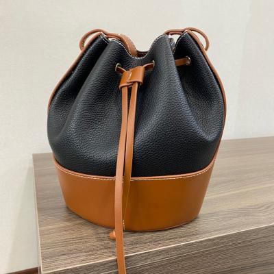 China Fashion / Newspaper Use New Niche Design Canvas Contrast Patchwork Bucket Bag One-Shoulder Soft Cross-Body Bag for sale