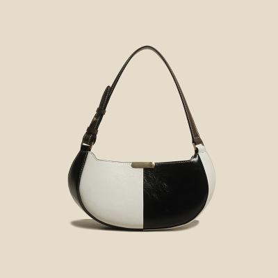 China Fashion / Daily Use Black And White Paneled Leather Armpit Bag European And American Vintage Saddle Bag for sale