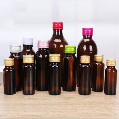 China Custom Liquid Glass Amber Round Bottle Oral Beverage Liquid Bottle 30ml 50ml 100ml Pharma With Aluminum Cap For Medicine Liquid Syrup for sale