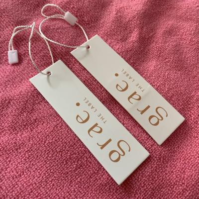 China Sustainable Custom Luxury Brand Hang Tag Garment Paper Hangtag Swing Tag For Garment And Bag for sale