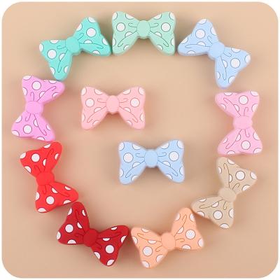 China Eco-friendly new trend product non-toxic eco-friendly silicone focal beads bulk cartoon 100% Food Grade Silicone beads Bowknot shape for sale