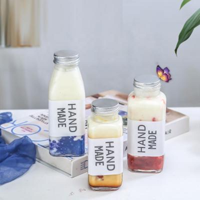 China Environmental Friendly Clear Empty Glass Juice Bottle 250ml 350ml 500ml Glass Beverage Bottles With Lid for sale