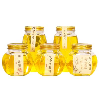 China Competitive Price 380ml 730ml Empty Hexagonal Glass Food Clear Honey Jar With Lid for sale