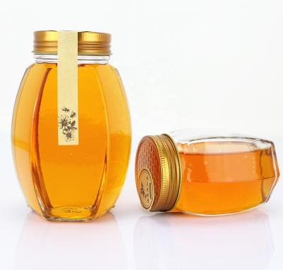 China Eco-Friendly Unique Hex Glass Honey Jar Airtight Oval Hexagonal Glass Honey Jar Food Hex with Metal Lip for sale