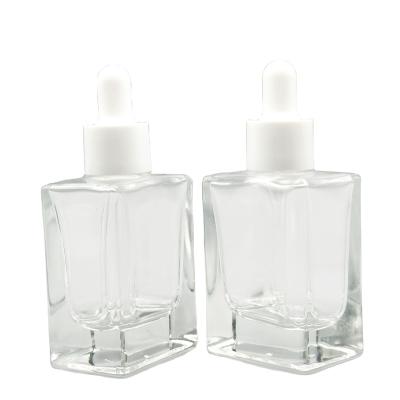 China Cosmetic Square Glass Bottle Essential Oil Custom Glass Bottle With White Dropper 30ml for sale