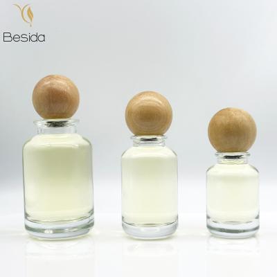 China Cosmetic Luxury Parfum Bottle 30ml 50ml 100ml Clear Round Glass Perfume Bottle Empty With Round Wooden Cap for sale