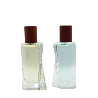 China Cosmetic Unique design 50ML glass bottle packaging for male/female with wooden cap  Free Sample  Pocket bottle for sale