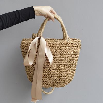 China Leisure Joker Ribbon Bow Grass Woven Bag Soft Beach Handbag for sale