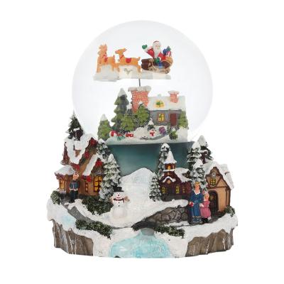 China 2022 Christmas Decoration Christmas Snow Globe Resin Glass Crystal Ball On Mountain Blue Decoration Snow Globe With Colorful Decor for sale