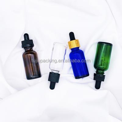 China 10ml 20ml 30ml 50ml 100ml Clear Green Blue Amber Essential Oil Glass Bottle Serum Dropper Round Cosmetic Glass Bottles for sale