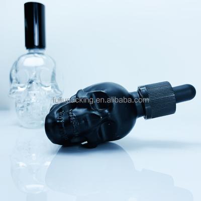 China Matte Black Transparent Skull Glass Essential Oil Bottle 15ml 30ml 50ml Skull E Juice Liquid Skull Glass Dropper Bottle for sale