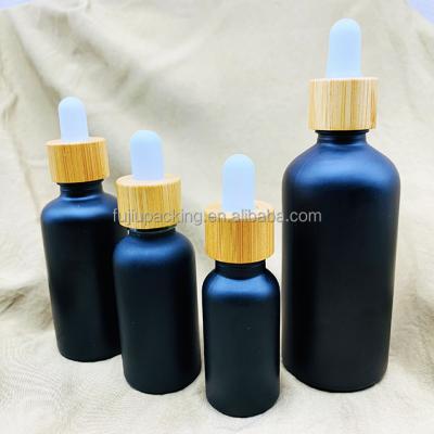 China 10ml 15ml 30ml Serum Bottles Glass Cosmetic Frosted Dropper Bottle With Bamboo Cap for sale