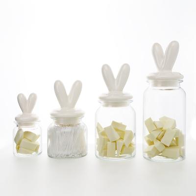 China Newest Design Art Stylish Decorative Ceramic Lid Airtight Storage Freshness Preservation Glass Jars Bottles for sale