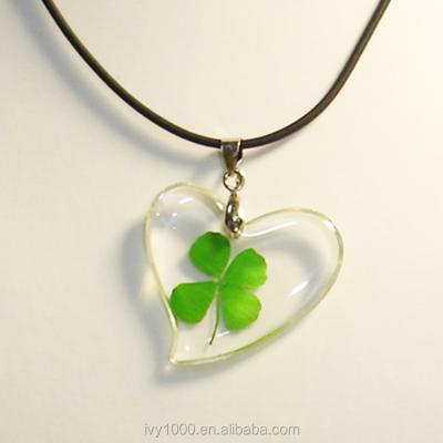 China Lucky Pendant Clear Resin Green Shamrock Fashionable Pendant Necklace String Leather Necklace for sale