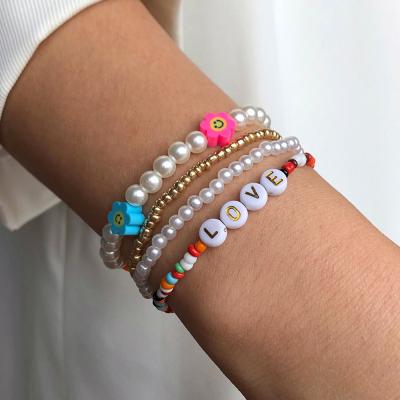 China Pearl Beads Vintage European Boho 4Pcs/Set Beaded Bracelet Polymer Clay Flower Pearl LOVE Letter Elastic Omen Bracelet Set for sale