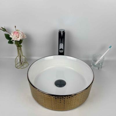 China Modern Circular Ceramic Countertops Hot Selling Gold Bathroom Sinks Gold Bathroom Vessel Sink for sale