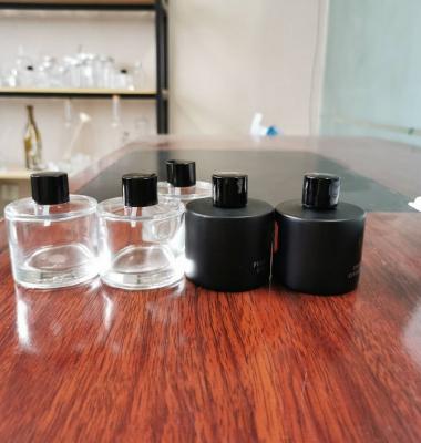 China Perfume 50ml Round Matte Black Tubular Diffuser Bottles Glass Perfume Bottles With Cover Essential Oil Bottles for sale