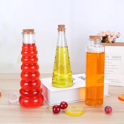 China Hot Selling Beverage Raindrops Shaped Juice Glass Bottles 350ml Glass Bottle For Beverage With Cork Lid for sale