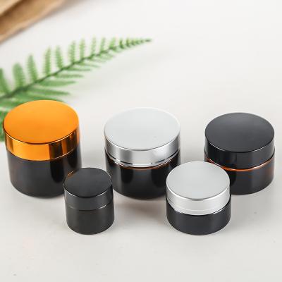 China Hot Sale 50gm Amber Glass Jars Cream Glass Cosmetic Jar With Black Lid Wholesale for sale