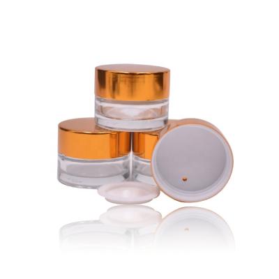 China Small Round 5g Cosmetic Empty Eye Cream Jar Mini Glass Pack 5g Eye Pack Jar With Gold Metal Lid for sale