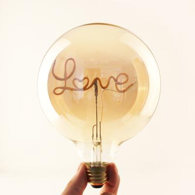 China All Use G125 4w E26 E27 Decorative Lighting Amber Glass Base With Word 'Love' Shape Home Flexible Soft Filament LED Bulb For Indoor Decorative Table Lamp for sale