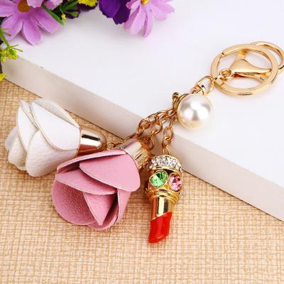 China Wholesale Lipstick Key Chain Leather Flower Faux Stone Lipstick Bag Key Chain Gift Pendant for sale