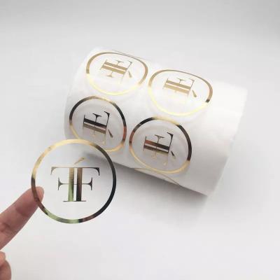 China Waterproof Custom Vinyl Circle Roll Clear Stickers Transparent Gold Foil Wrapping Labels Roll Up Printing for sale