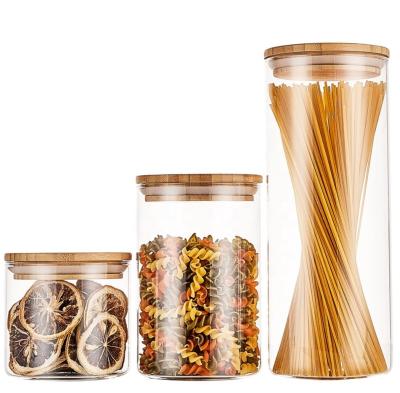 China Fashionable Hot Sale Jar Cylinder Storage Glass Jar With Lid Bamboo Kitchen Glass Container For Food for sale