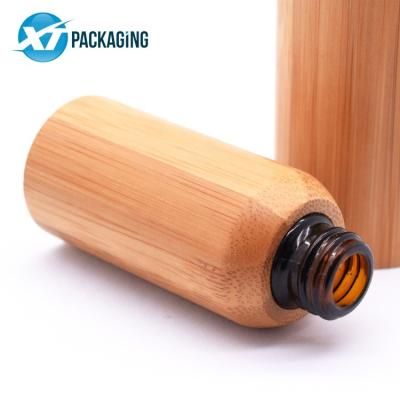 China Essential oil 30ml tincture cosmetic empty glass dropper bottles jars black bamboo cap glass bamboo top 10ml dropper bottle for sale