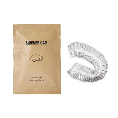 China Wholesale Viable Hotel Spa Transparent Shower Hat CE Certification Disposable Plastic Shower Caps With Kraft Paper Bag Packing for sale