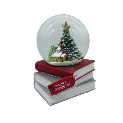 China Europe 2021 New Year Kids Gift Xmas Water Ball Decor 120MM Resin Book Glass Christmas Snow Globes With Music for sale