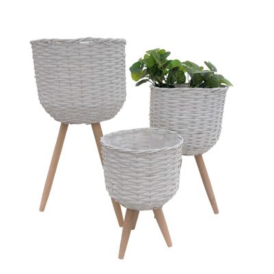 China CLASSIC Plant Flower Basket Wicker Planter With Wooden Legs For Garden Decoration for sale