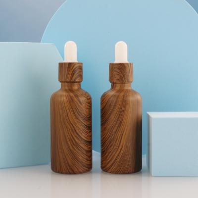 China 30ml personal care packaging eco-friendly wooden bamboo cap bamboo cap dropper glass bottle for essential oil for sale