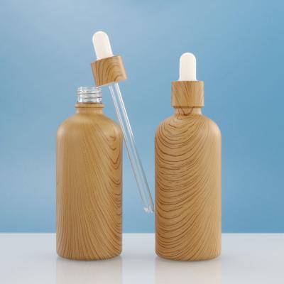 China Low moq cosmetic customize 30ml 1oz bamboo essential oil glass bamboo cap dropper bottle with bamboo cap for sale