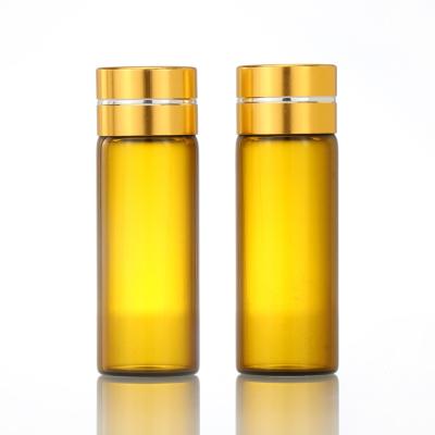 China Hot Selling Cosmetic Screw Bottle Amber Glass Essential Oil Bottle Vials With Gold Cap for sale