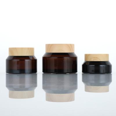 China Cosmetic hot sale 15g 30g 50g amber glass cosmetic bottle Glass Cosmetic Jar with wood grain lid for sale