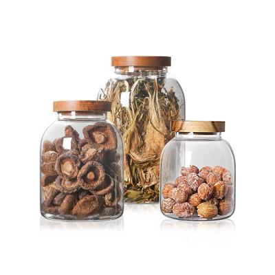 China Wholesale freshness preservation kitchen storage jar larga borosilicate glass jar with weooden lid for sale