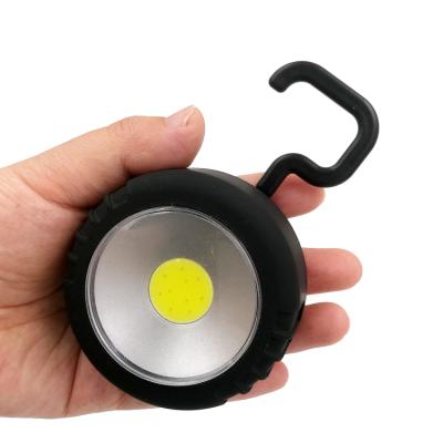 China Anywhere Portable Round Cordless AAA COB Battery Work Lightweight Magnetic Work Light With Rotating Hook for sale