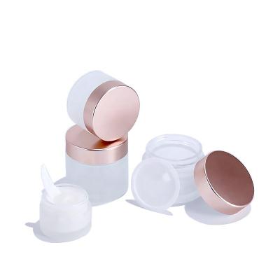 China Empty bottle 30ml 50ml luxury cosmetic packaging cosmetic skin care frosted round glass cream bottles with pink glod lid wholesale for sale