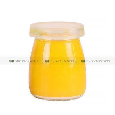 China Wholesale 100ml Round Food Storage Container Milk Pudding Bottles Empty Glass Yogurt Jars With Plastic Lid for sale