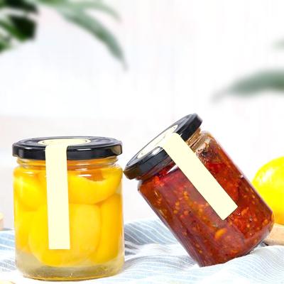 China Food Round Food Grade Storage Jam Sauce Canned Pickle Honey Glass Jar With Metal Lids for sale