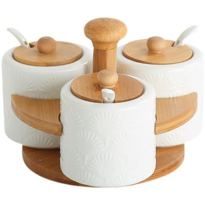 China Freshness Preservation Pure White Ceramic Kitchenware Jar Jar Storage Seasoning Bottle With Lid Shelf Wood Tray for sale