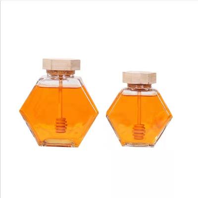 China CLASSIC 100ml 220ml 280ml Empty Storage Hexagon Honey Bottle Jars With Wooden Dropper for sale